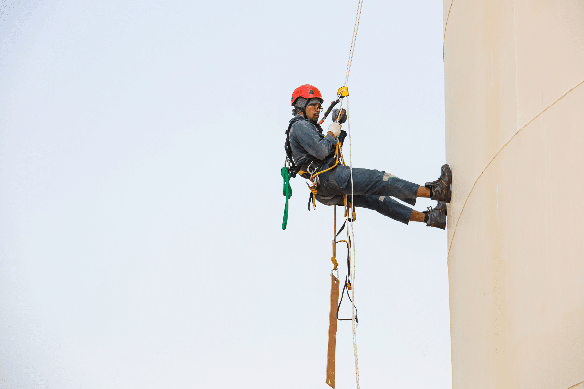 A Severn Access rope access technician working at height on a chimney