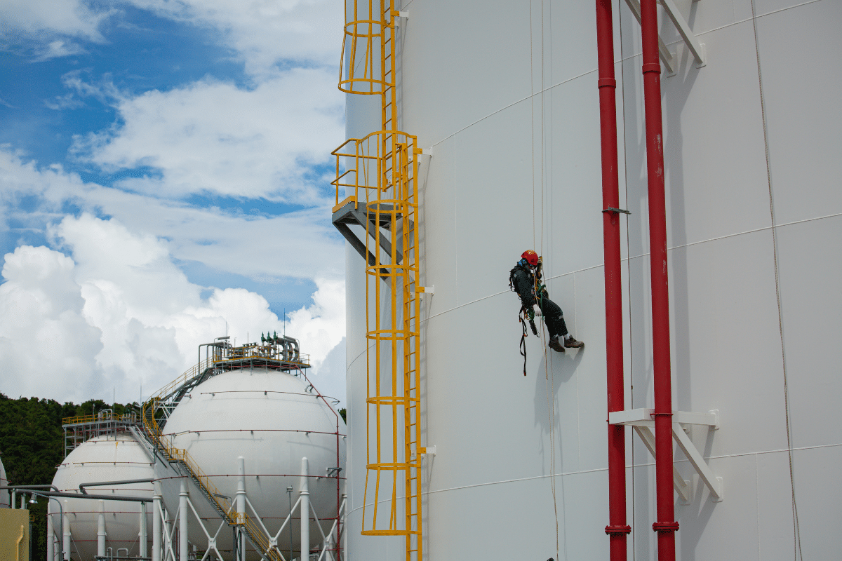 A Severn Access rope access technician performing cladding repairs on a silo