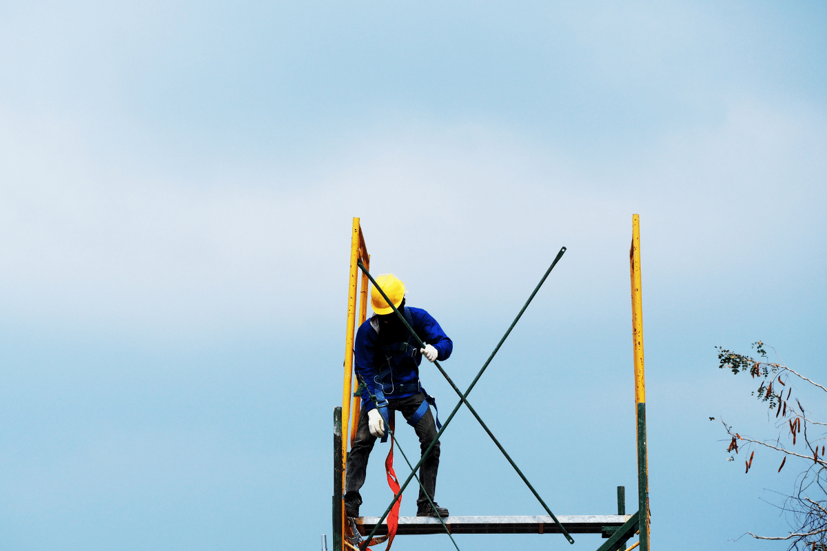 A Severn Access rope access technician performing cladding repairs on top of a building