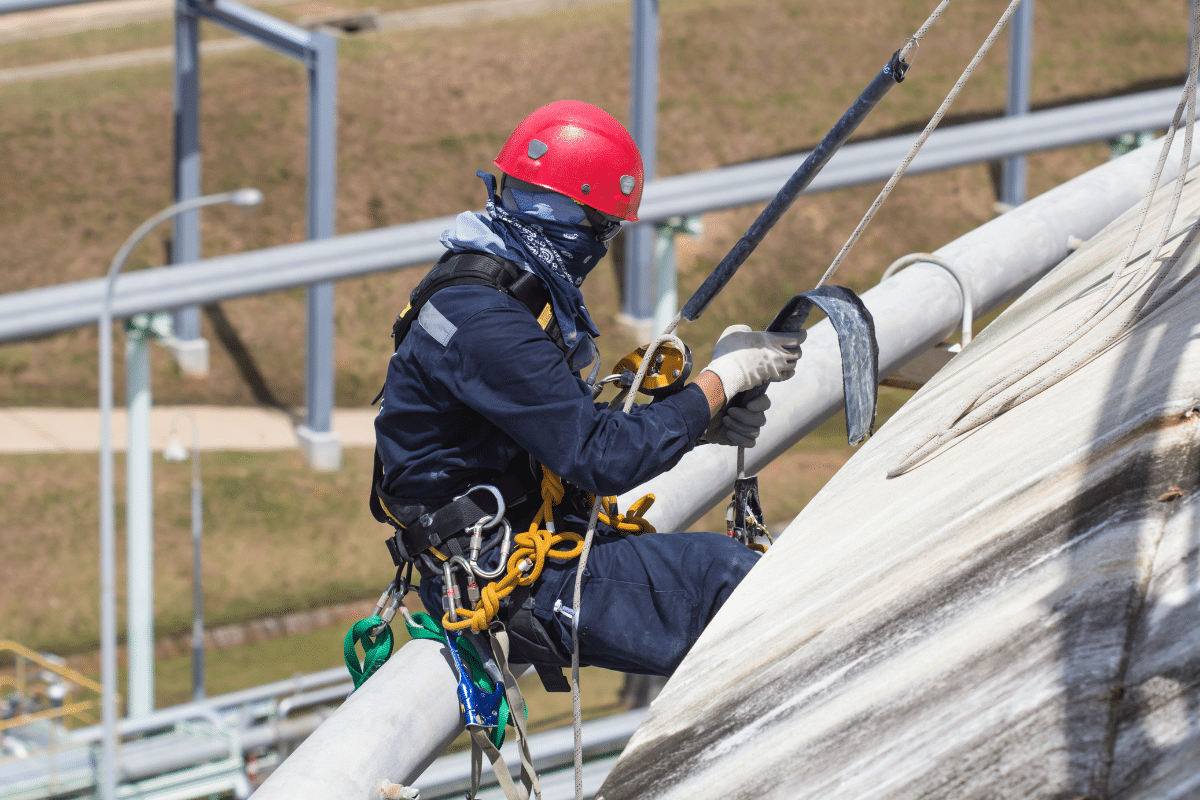 A Severn Access rope access worker performing cladding repairs on on top of a building