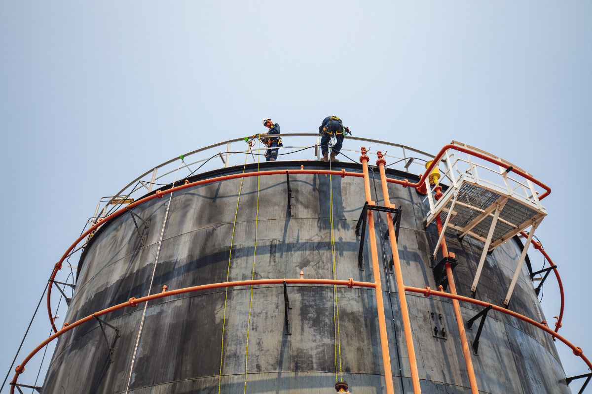 Two Severn Access rope access technicians carrying out silo cleaning on a silo