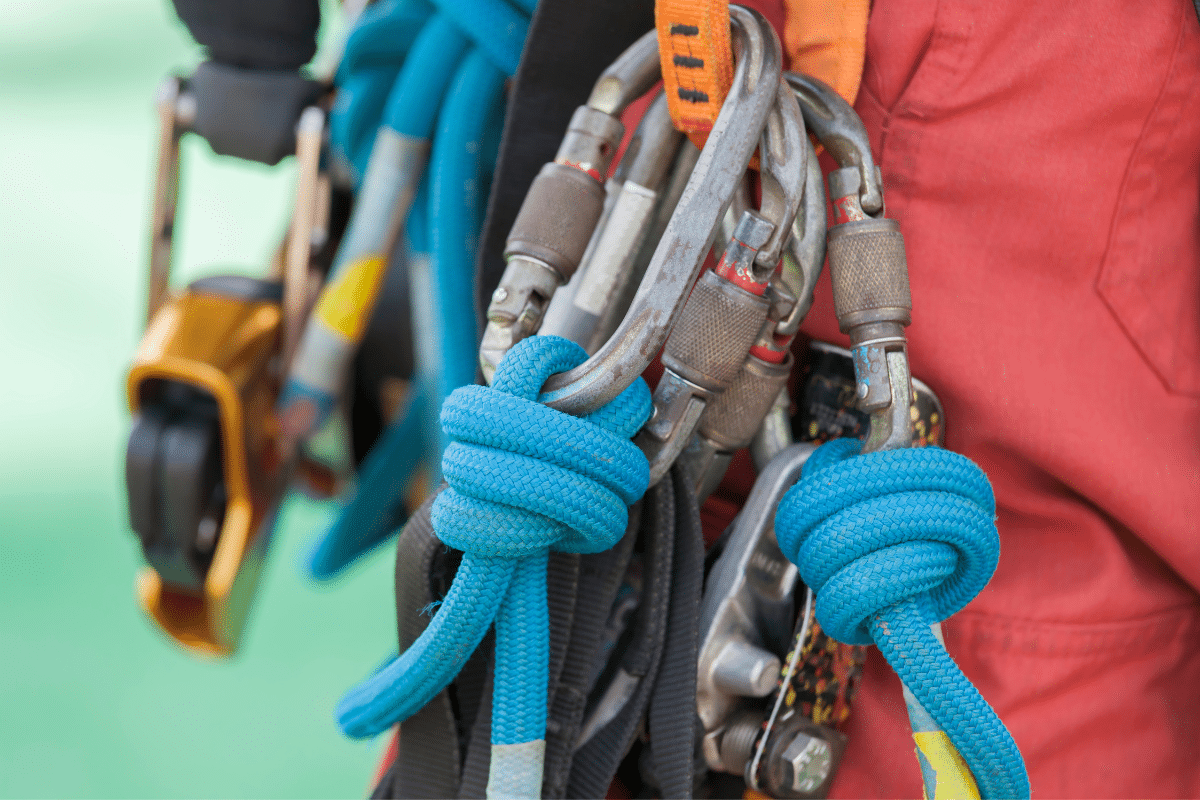 Hooks and buckles on the belt of a Severn Access worker performing cladding repairs