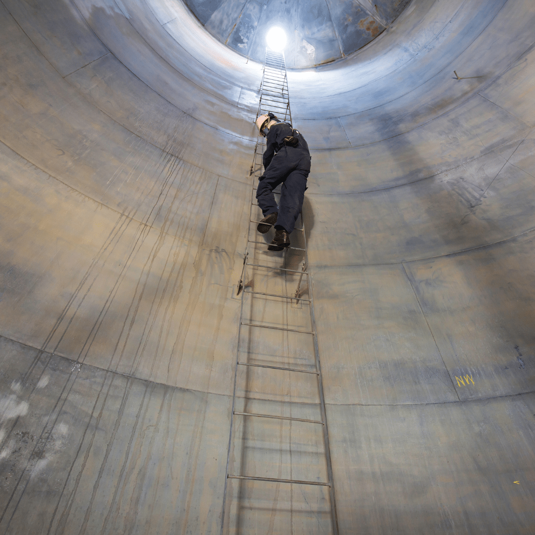 A worker descending into a confined space in Birmingham with a Severn Access confined space rescue top man above