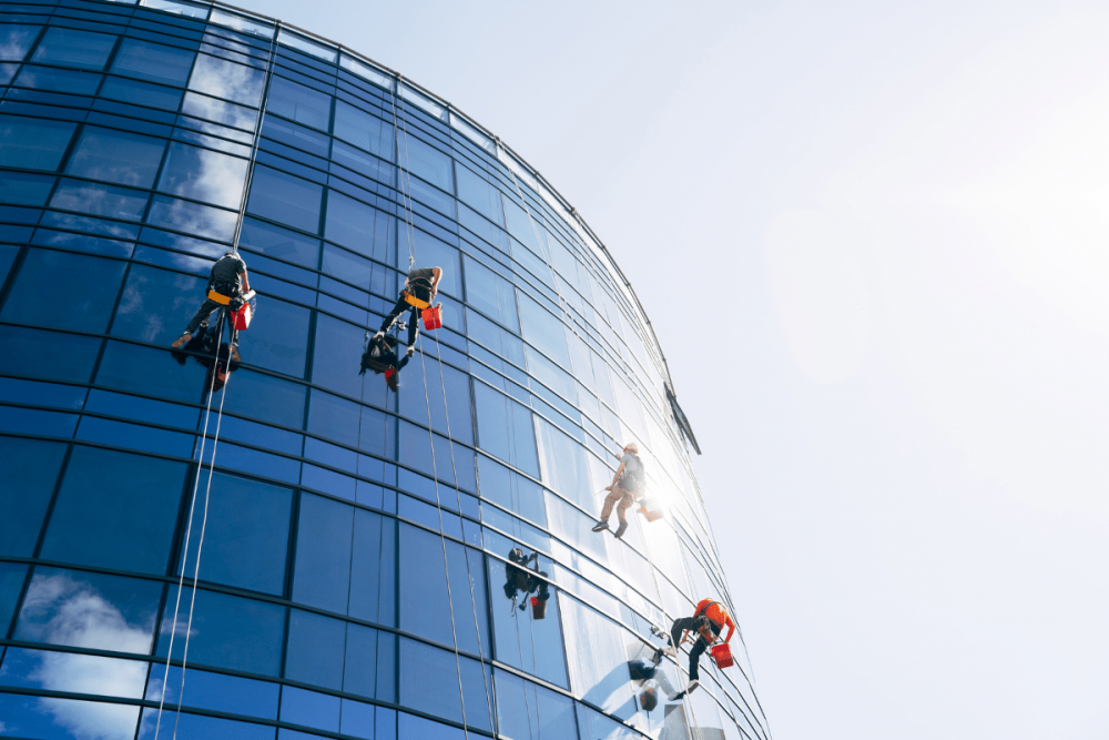 Four Severn Access technicians executing industrial rope access services and solutions on a high rise building