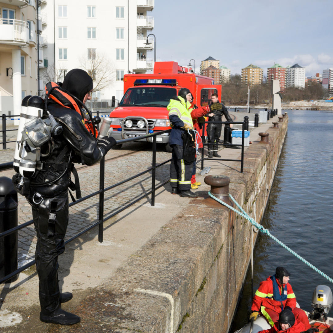 safety-boat-hire-services Severn Access crew members preparing for a water rescue operation at a harbour