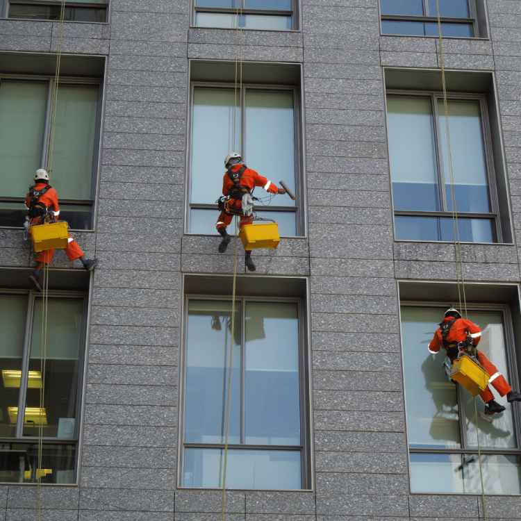 Three Severn Access technicians carrying out commercial Birmingham window cleaning services on a high-level building