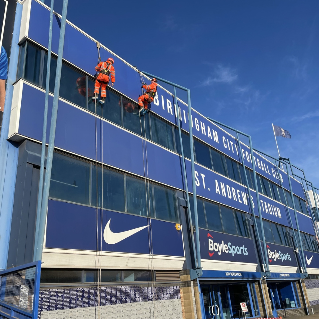 Severn Access technicians performing rope access window cleaning on a football stadium.
