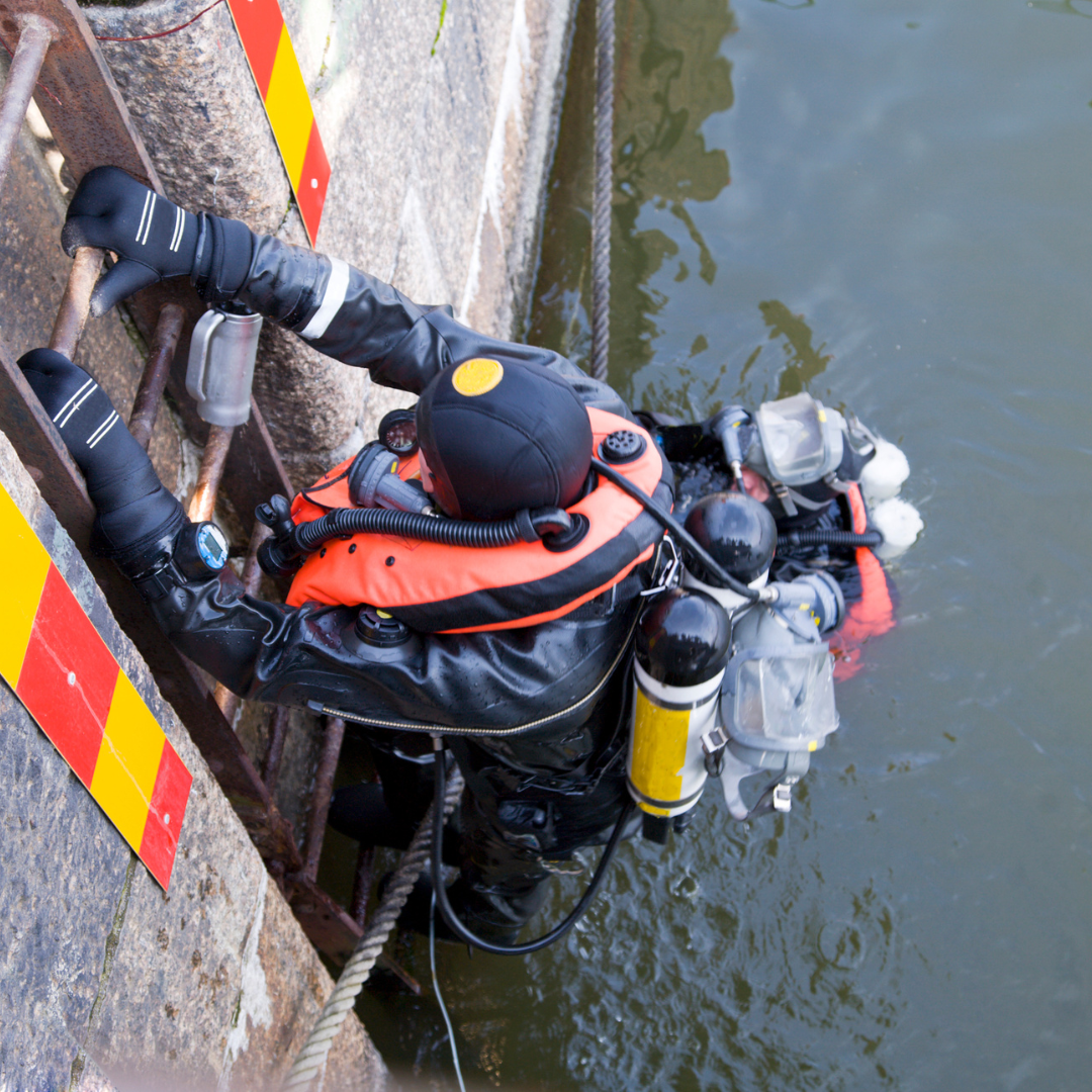 A Severn Access water rescue operative descending into water: water rescue services UK
