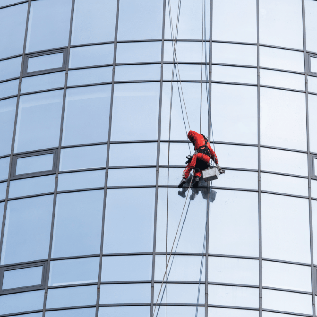 A Severn Access technician carrying out commercial Birmingham window cleaning services on a high-rise building